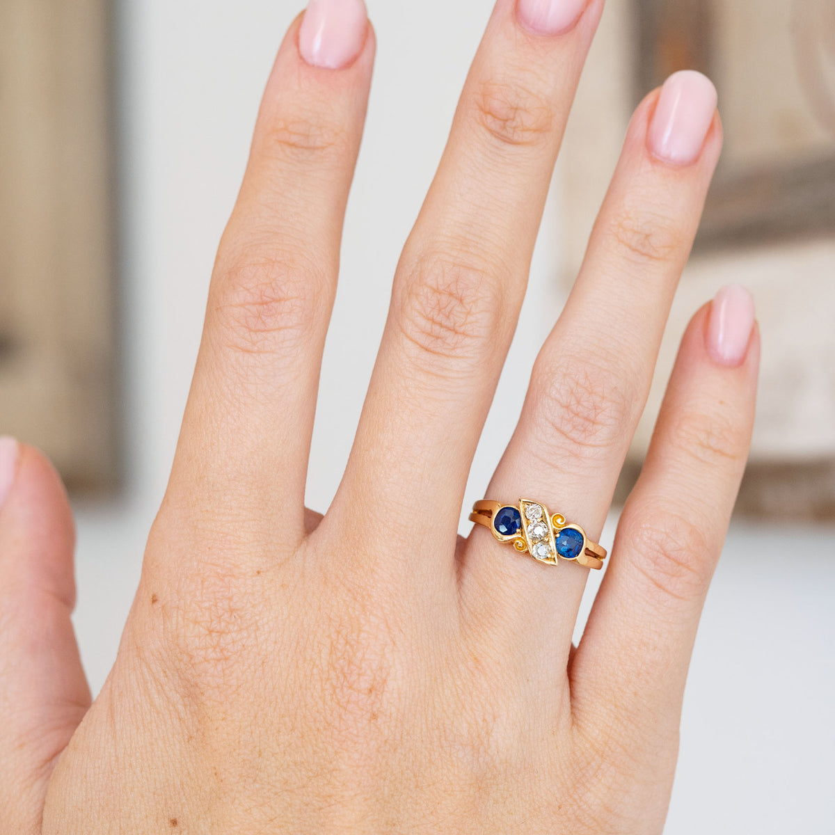 Modelled on the hand, the Victorian ring creates a distinctive asymmetrical arrangement of sapphires and old-mine diamonds.