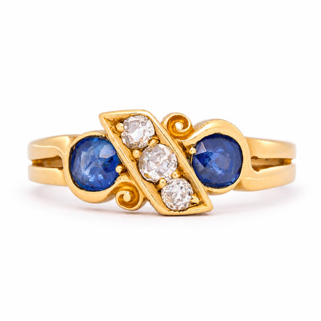 Antique Victorian five-stone engagement ring combining two cushion-cut blue sapphires with three cushion old-mine cut diamonds yellow gold.