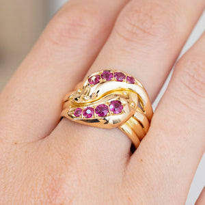 Detailed hand shot of the Victorian snake ring, showing four natural rubies set along each entwined serpent.