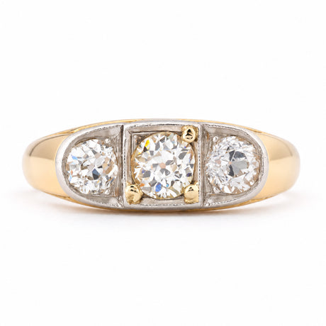 Antique Edwardian diamond three-stone engagement ring in yellow gold and platinum, featuring three round old-cut diamonds in a platinum setting with a broad yellow gold band.