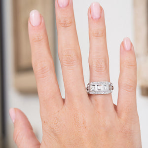 Antique diamond engagement ring worn on the hand, displaying the distinctive elongated Art Deco cluster.