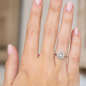 Antique geometric diamond cluster displayed on the hand, showing the ring’s elegant scale and crisp hexagonal outline.