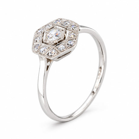 Three-quarter studio view of the antique diamond ring, showcasing its layered Art Deco cluster and slender white gold band.