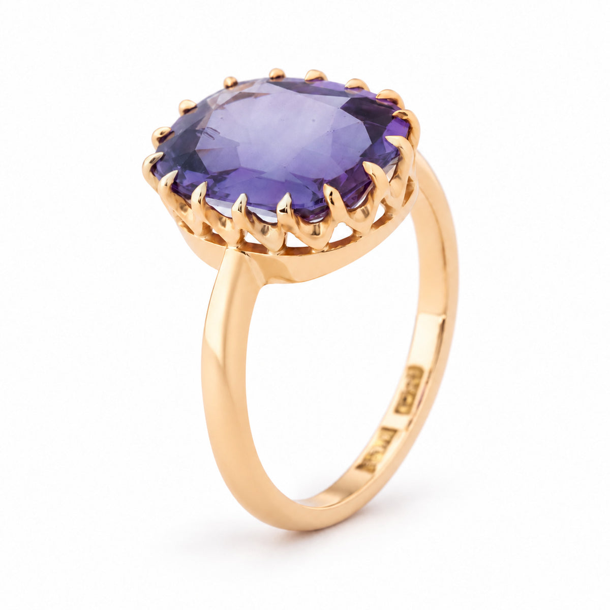 Angled view of the Edwardian sapphire ring, highlighting the raised multi-claw setting and polished yellow gold band.