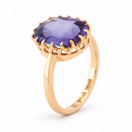Angled view of the Edwardian sapphire ring, highlighting the raised multi-claw setting and polished yellow gold band.