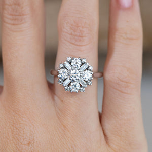 Close-up of the 1980s diamond cluster engagement ring worn on a finger, showcasing its intricate geometric detailing.