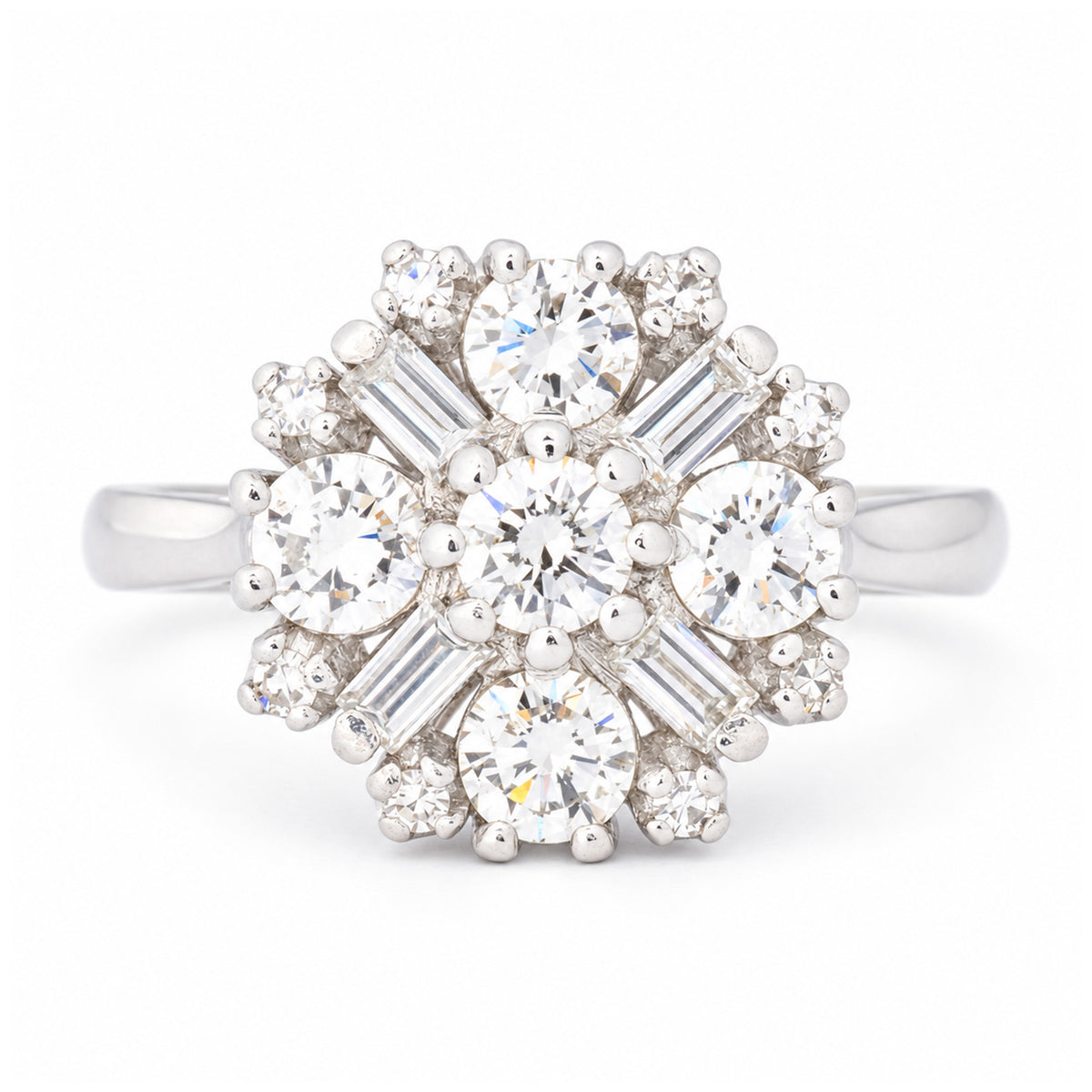 Vintage 1980s diamond cluster engagement ring in white gold, featuring round brilliant-cut and baguette-cut diamonds in a floral-inspired design.