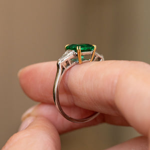 Profile detail of the vintage three-stone ring, revealing the open gallery, yellow gold claws and slender white gold shank.