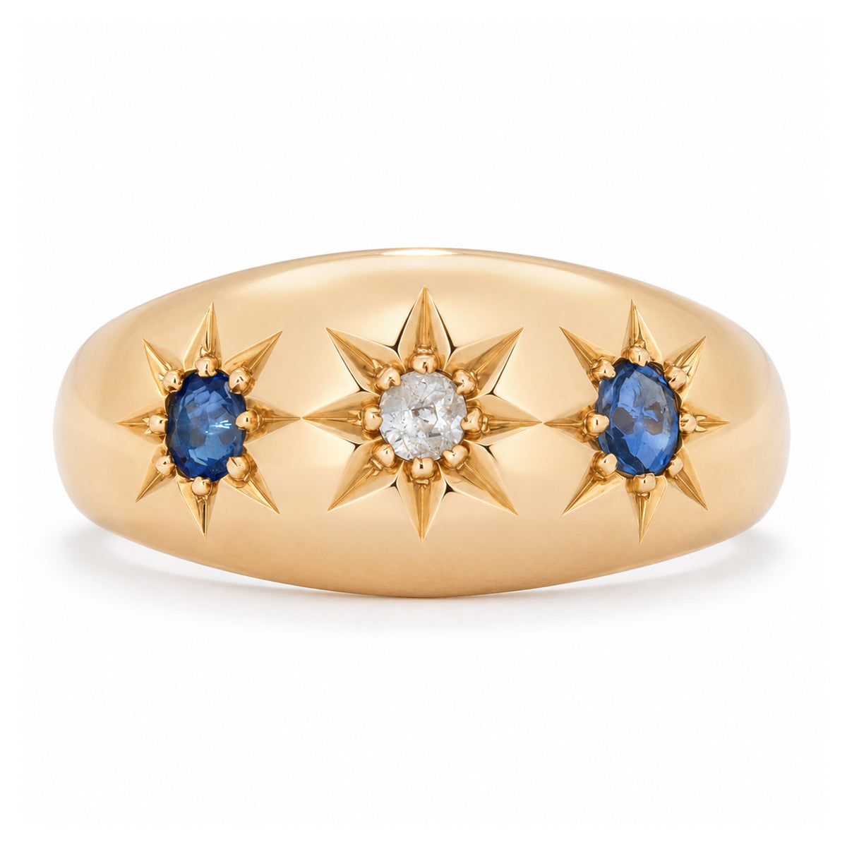 Antique Edwardian sapphire and diamond three-stone gypsy ring in yellow gold, featuring two blue sapphires and a central diamond in star settings.