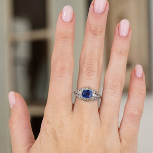 Worn on the hand, this antique sapphire bombé ring displays its rich blue centre stone and beautifully tapered diamond-set shoulders.