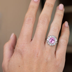 1960s pink sapphire and diamond engagement ring worn on the hand, displaying its bold vintage proportions.