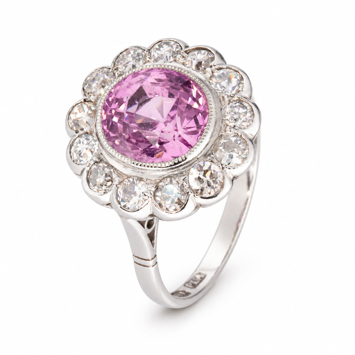 Three-quarter studio view of the vintage sapphire ring, showcasing its floral diamond cluster and elegant split shoulders.