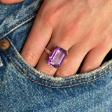 Vintage, Art Deco amethyst cocktail ring worn on hand in pocket of jeans.