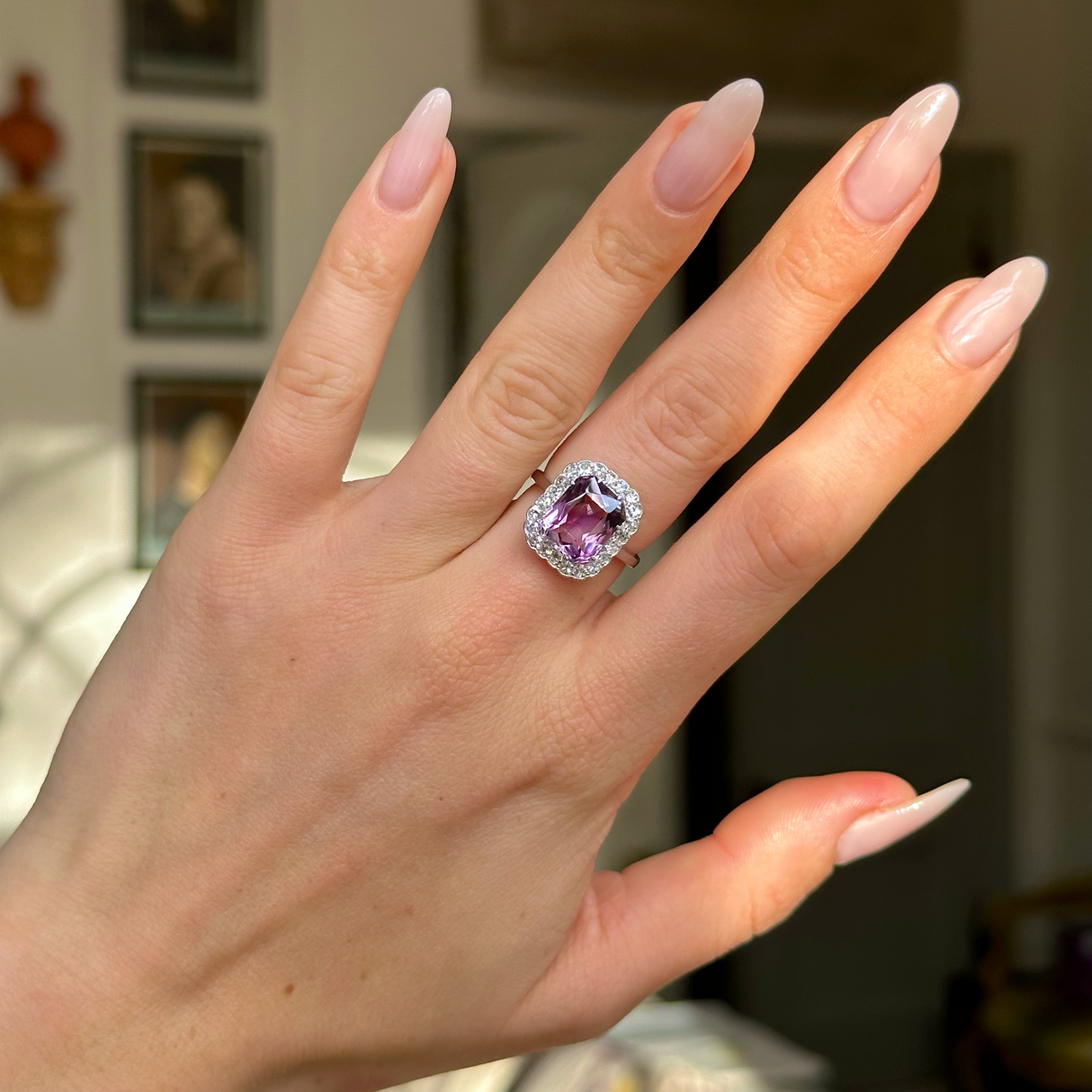 antique belle epoque amethyst and diamond cluster ring worn on hand. 