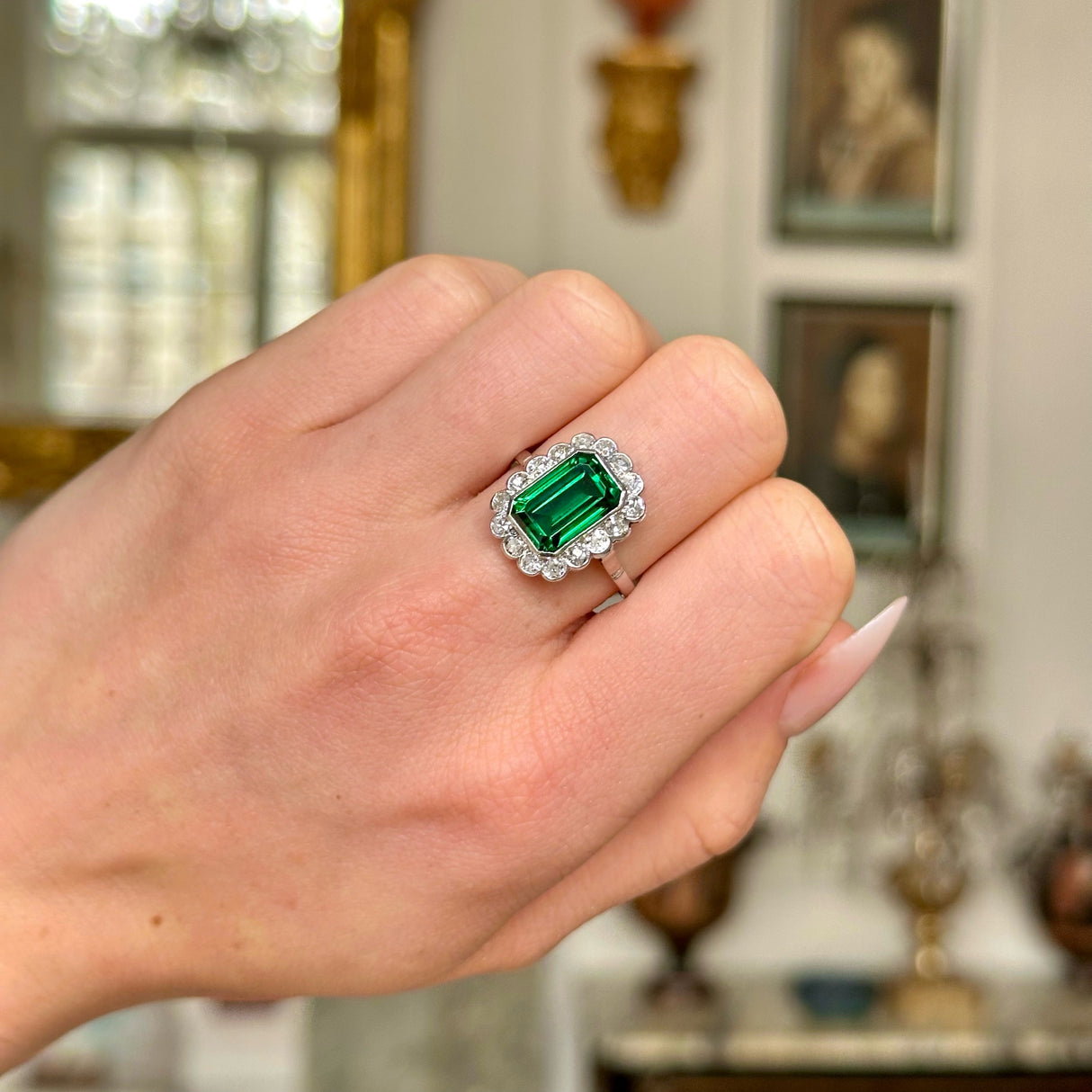 Antique green paste and diamond cluster ring, worn on closed hand. 