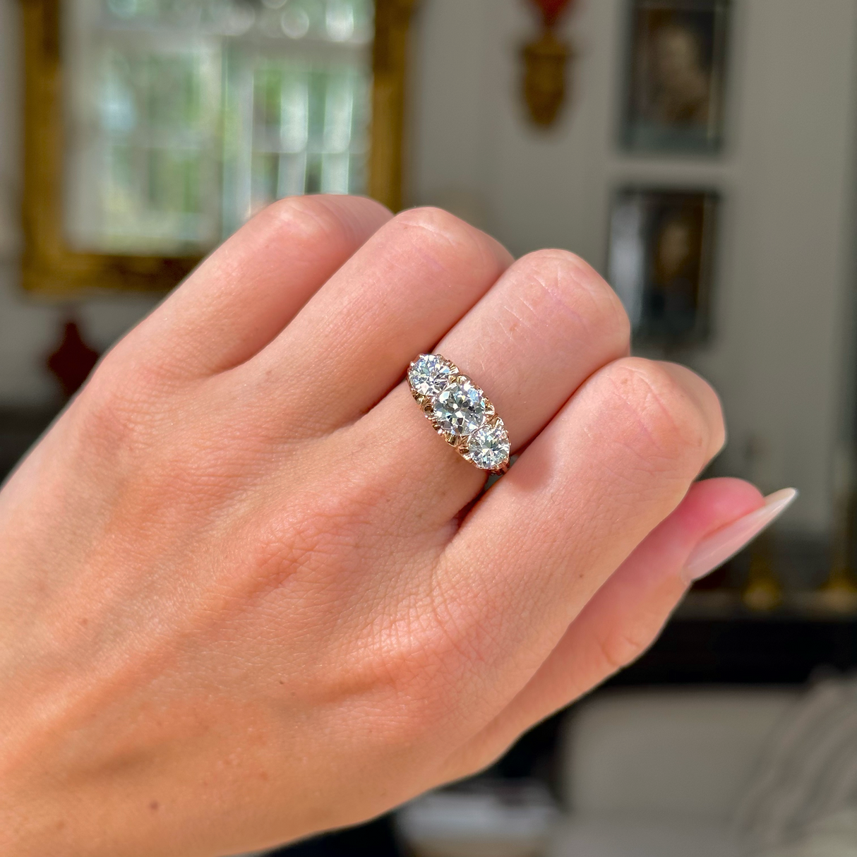 three stone antique italian diamond engagement ring, worn on closed hand, front view. 