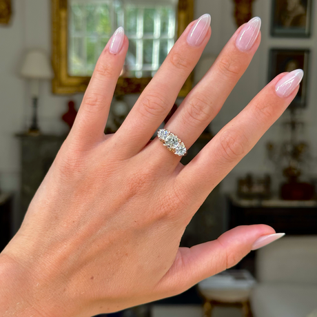 three stone antique italian diamond engagement ring, worn on hand, front view. 