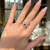 Antique victorian ruby and diamond cluster engagement ring worn on hand. 