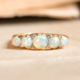 An Antique Edwardian five-stone opal and diamond ring set in yellow gold. 