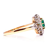 Antique emerald and diamond cluster ring, side view.