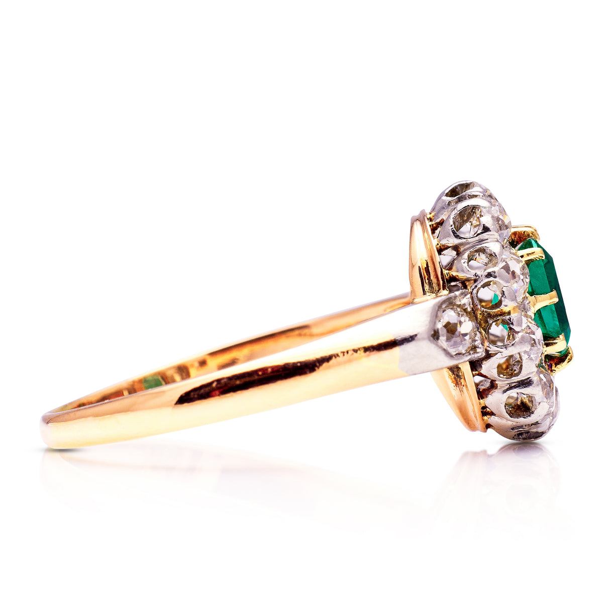 Antique emerald and diamond cluster ring, side view.