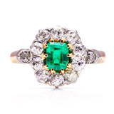 Antique emerald and diamond cluster ring, front view.