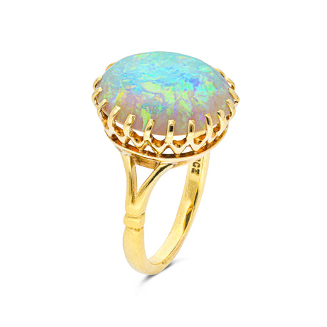cabochon white opal cocktail ring with 18ct yellow gold band, side view. 