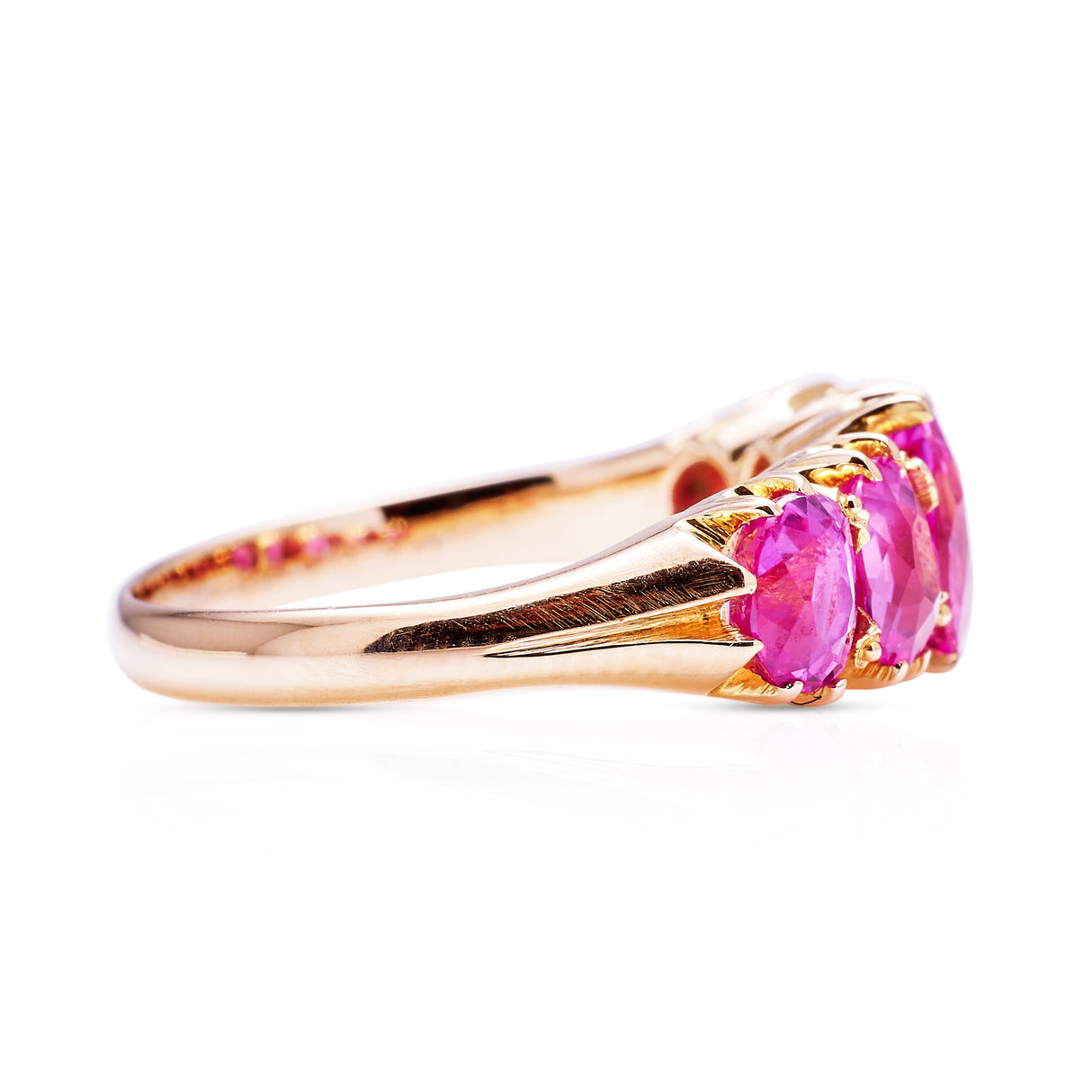 Five stone pink sapphire and yellow gold ring, side view
