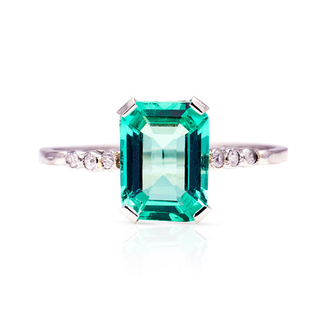 Antique single stone emerald and diamond ring, front view. 