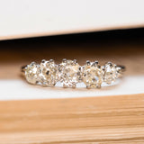 An Antique, Victorian old-mine cut diamond five-stone engagement ring with silver claws and yellow gold band 