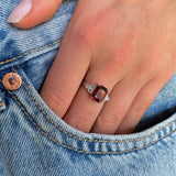 Art Deco garnet and diamond engagement ring, worn on hand.
