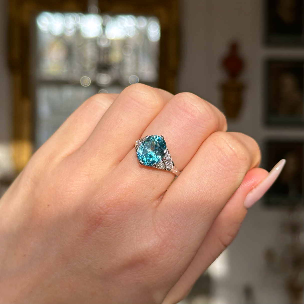 Art deco zircon and diamond ring worn on  closed hand.