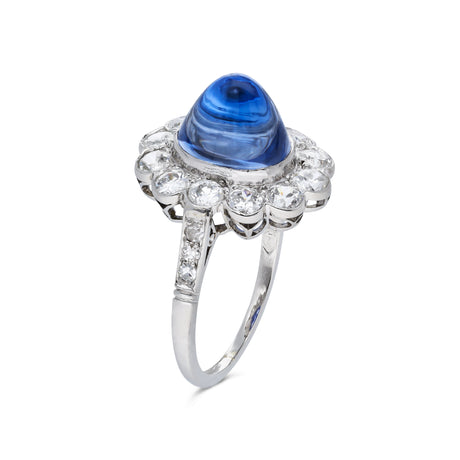 cabochon sapphire and diamond cluster ring set in platinum, side view.