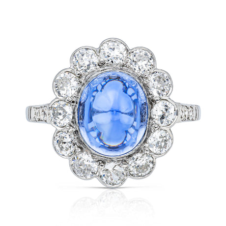 cabochon sapphire and diamond cluster ring set in platinum, front view.