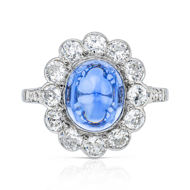 cabochon sapphire and diamond cluster ring set in platinum, front view.