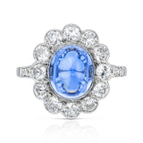 cabochon sapphire and diamond cluster ring set in platinum, front view.