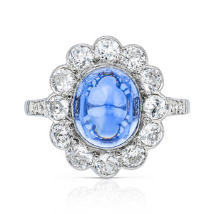 cabochon sapphire and diamond cluster ring set in platinum, front view.
