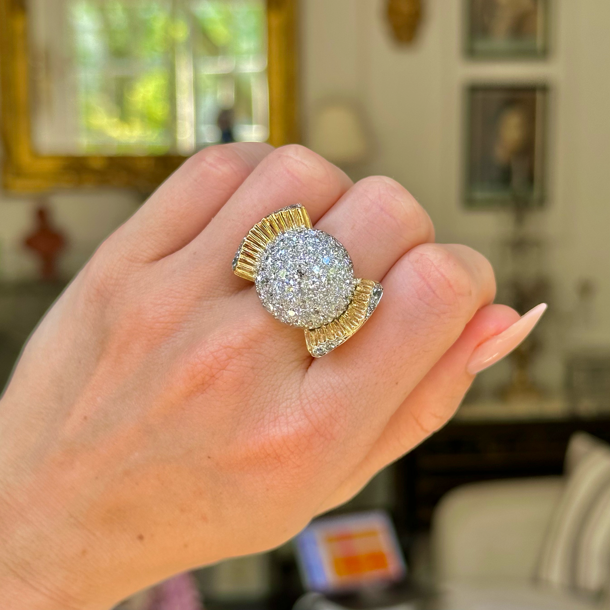 Cartier diamond bombe ring, front view. Worn on hclosed hand.