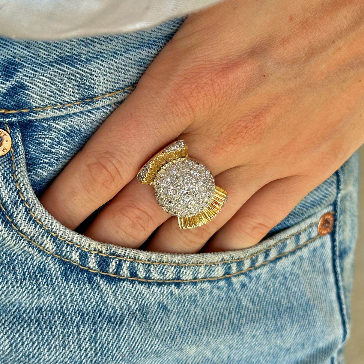 Cartier diamond bombe ring,  worn on hand in pocket of jeans.