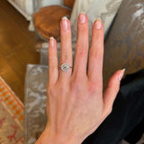 Diamond cluster yellow gold engagement ring on ring finger showing proportions. 
