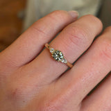 Diamond three-stone engagement ring on hand close up to show details