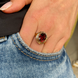 Belle Époque red garnet ring, worn on hand in pocket of jeans.