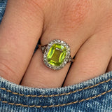 antique peridot and diamond ring, worn on hand in pocket of jeans,  front view.