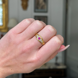 edwardian ruby and diamond 18ct yellow gold band on closed hand, front view.