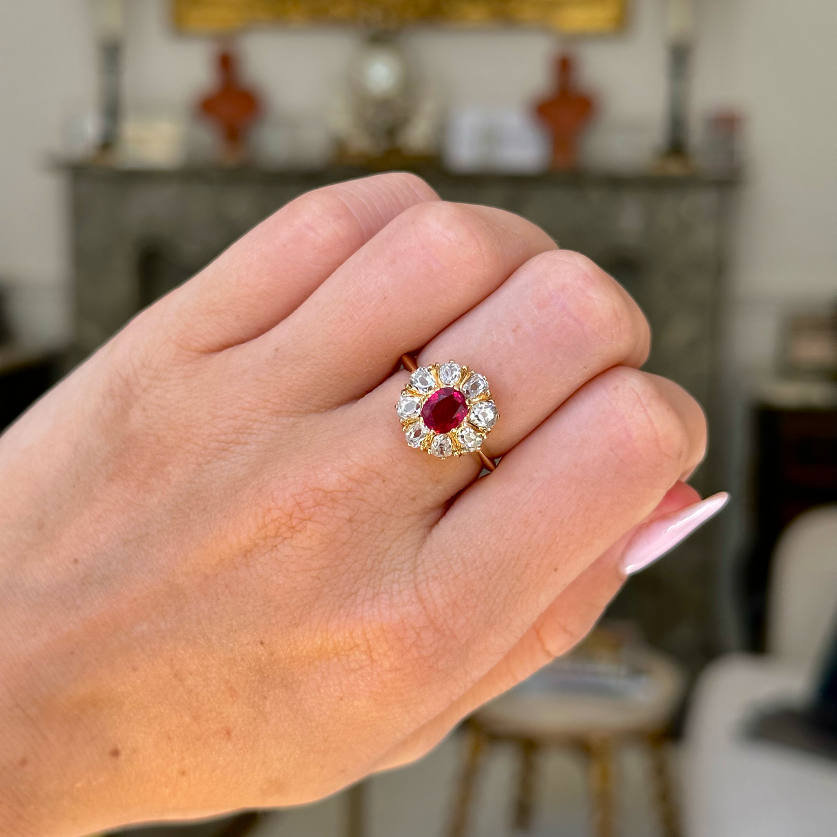 antique ruby and diamond cluster, worn on closed hand, front view.