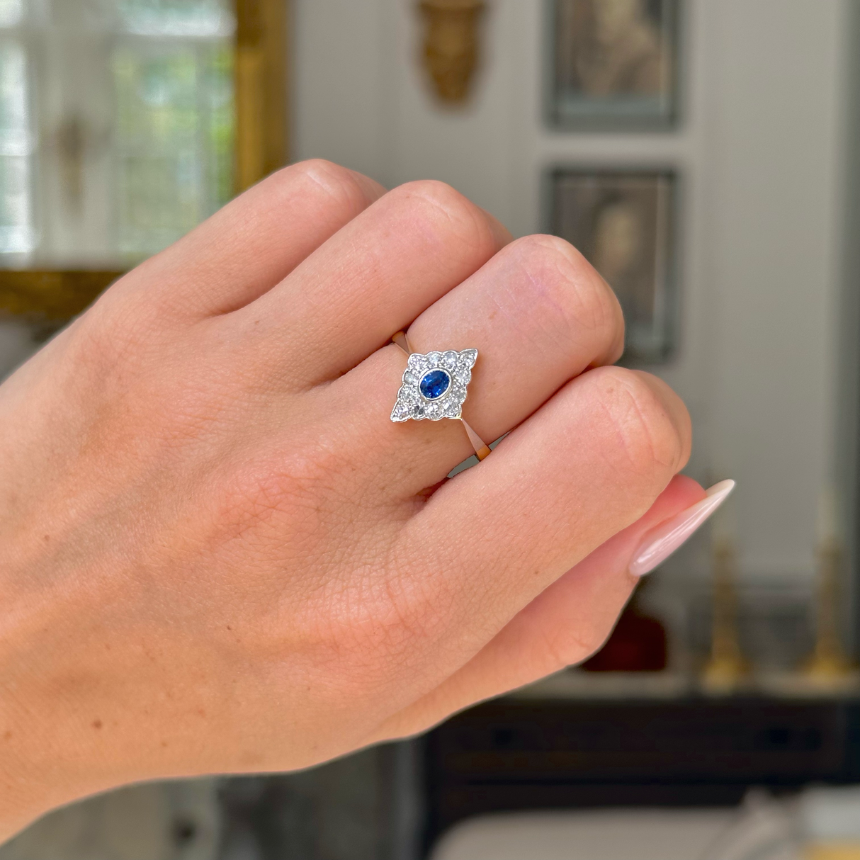 antique edwardian sapphire and diamond kite shaped ring, worn on closed hand, front view