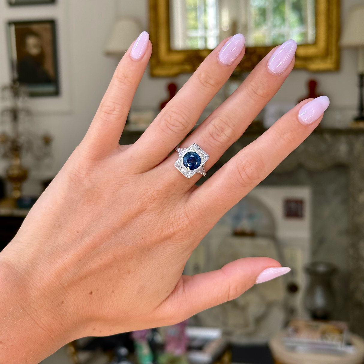 sapphire and diamond panel ring worn on hand. 