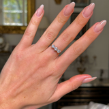 three stone diamond engagement ring,worn on hand, front view.
