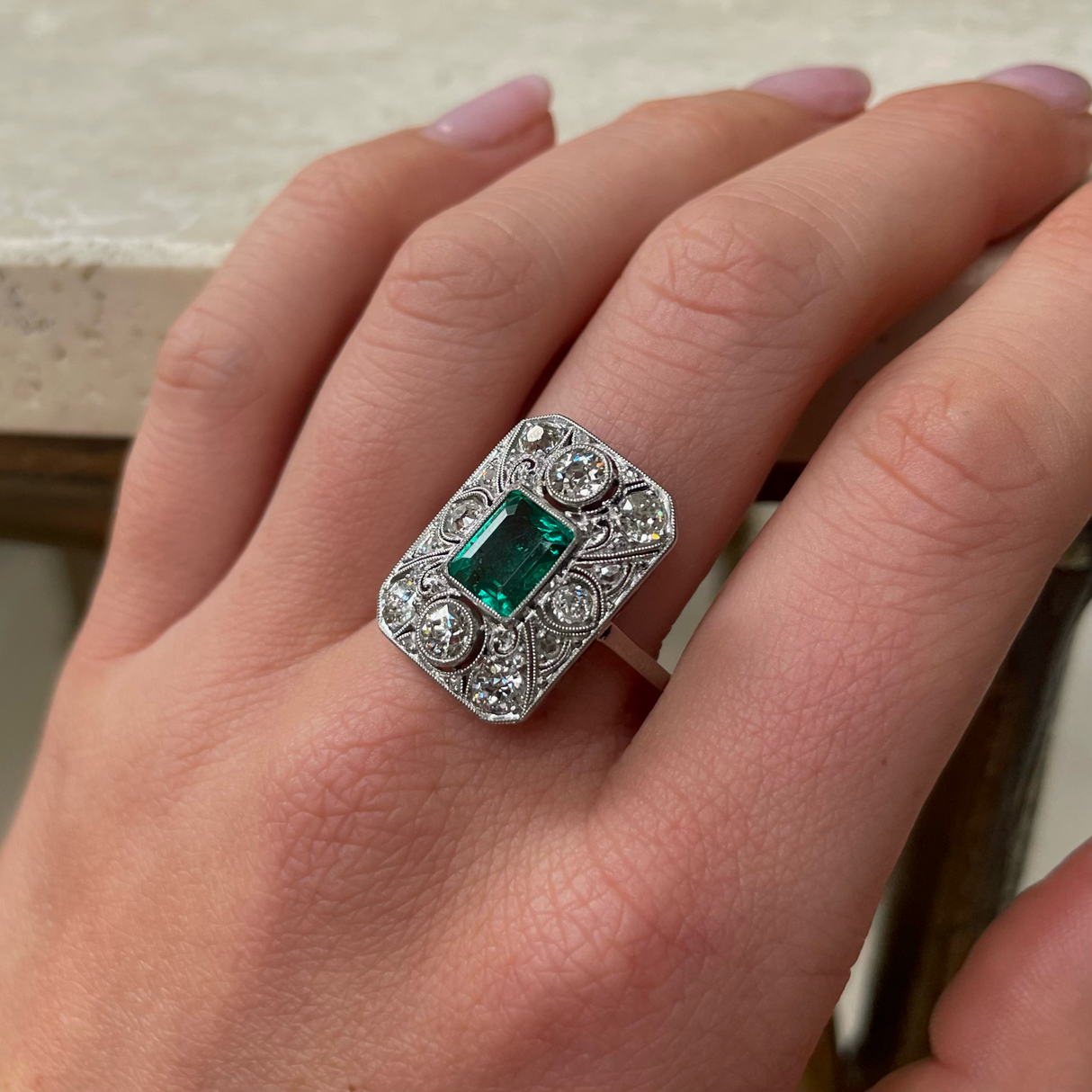 Art Deco emerald and diamond panel ring, worn on hand