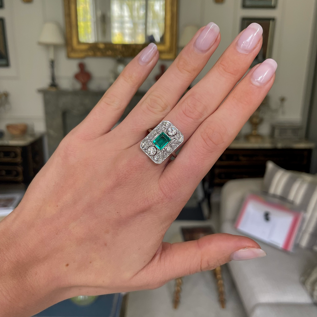 Art Deco emerald and diamond panel ring, worn on hand.